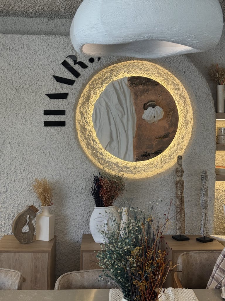 Modern interior design with a unique round mirror and stylish decor elements.