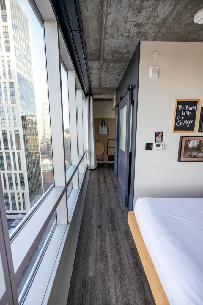 A chic modern bedroom interior in a Boston high-rise with city views.