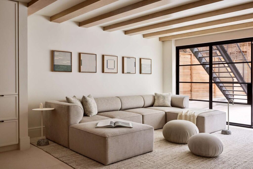 Modern living room interior with warm neutral colors, curved furniture and minimalist 2025 design style.”